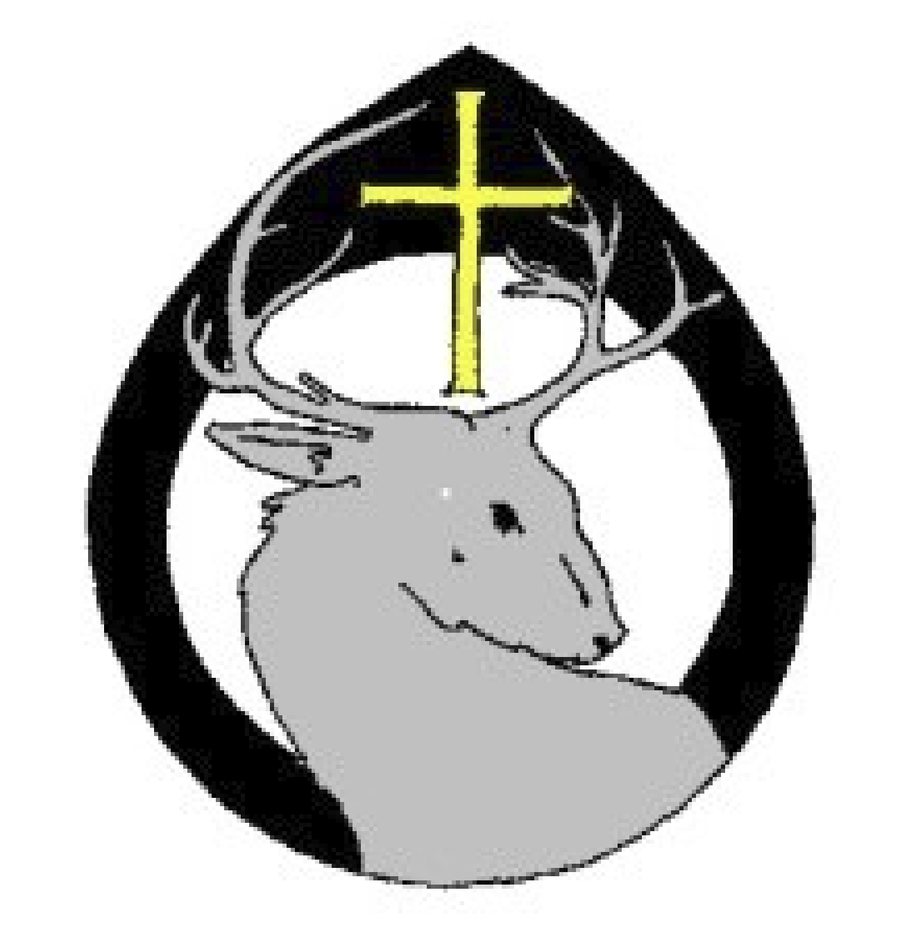 The parish's existing mark: a grey stag's head beneath a yellow cross, inside a black pointed-arch frame.